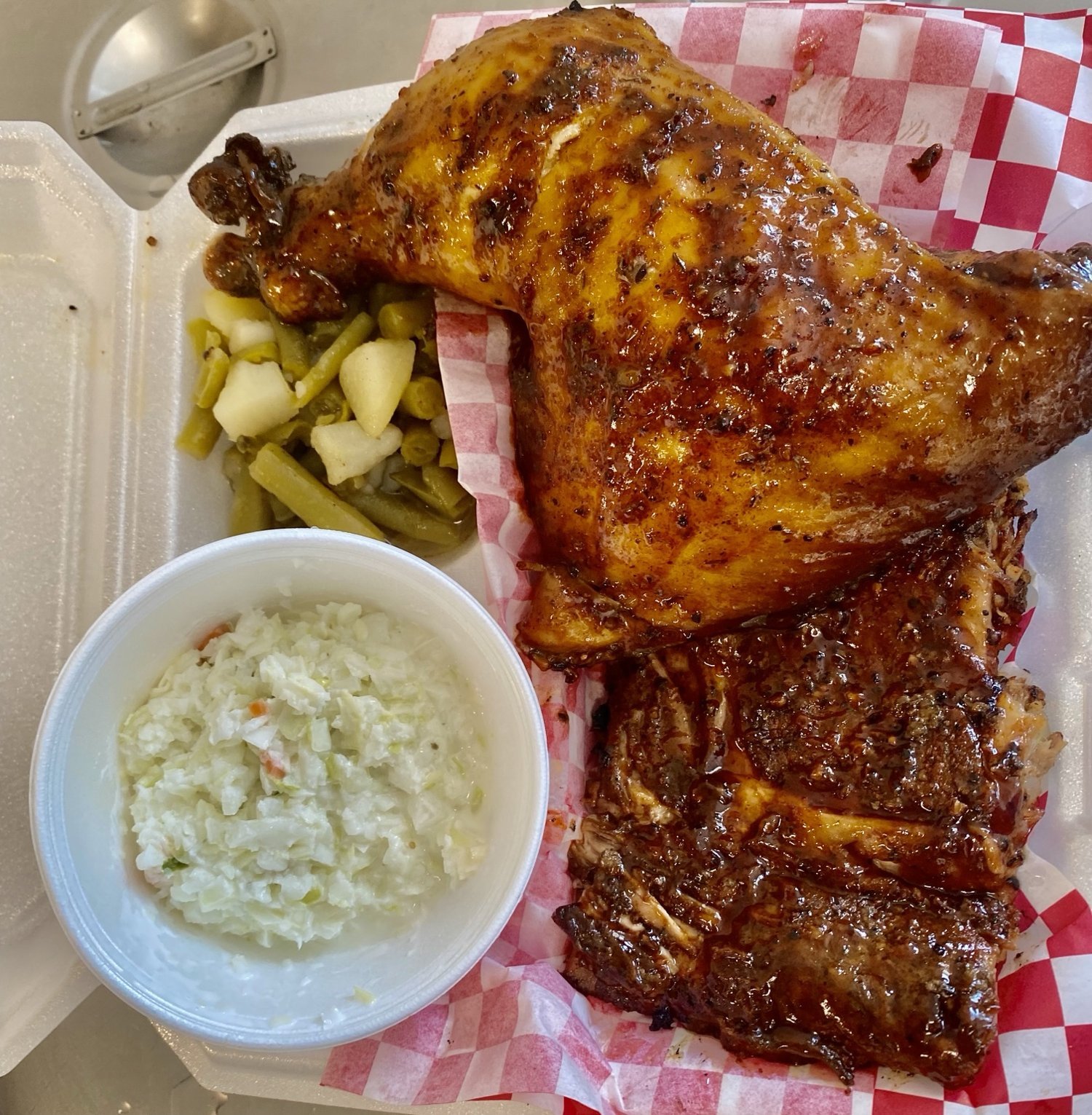 Smoked chicken dinner with ribs, coleslaw, and green beans